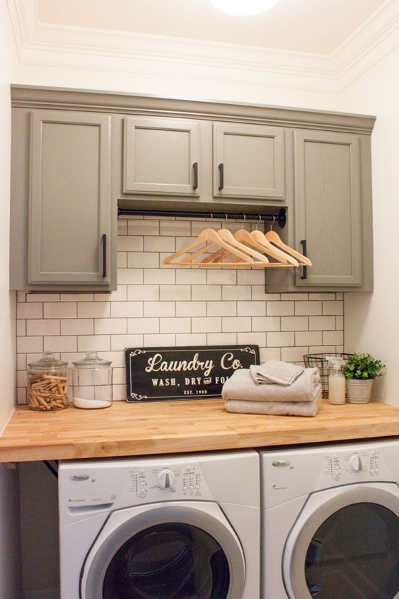 Organized laundry room with tile backsplash by Gather and Flourish